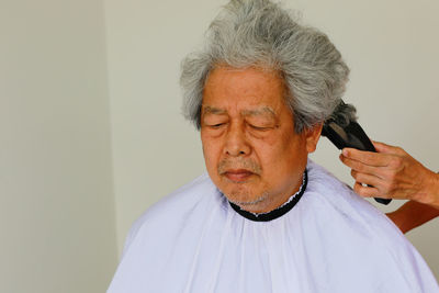 Portrait of man against wall