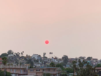 Buildings against sky at sunset