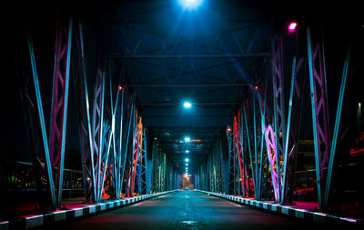 Illuminated lights on bridge at night