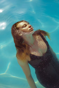 High angle view of woman swimming in pool