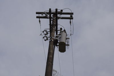 Low angle view of telephone pole against sky