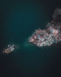 High angle view of rocks by sea