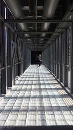 Rear view of man walking in corridor