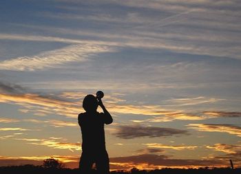 Silhouette of people at sunset