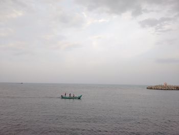 Scenic view of calm sea against cloudy sky