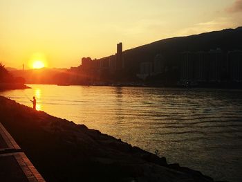 Scenic view of river against sky during sunset