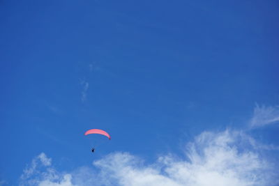 Low angle view of kite flying against blue sky