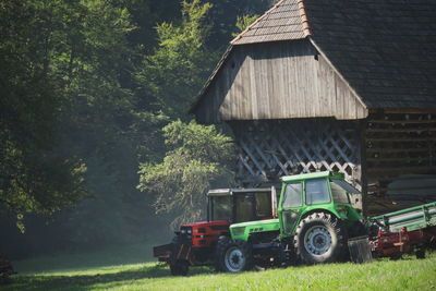 Tractor on field against trees