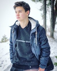 Young man standing in snow