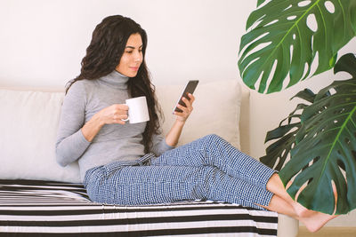 Young woman using mobile phone outdoors