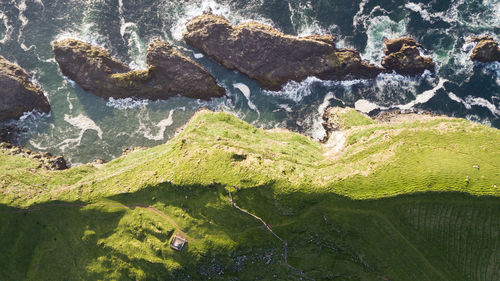 High angle view of cliff by sea