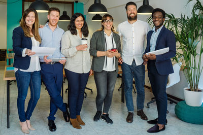 Low angle view of business colleagues standing against wall