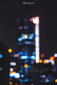 Defocused image of illuminated city at night