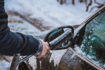 Midsection of person holding ice during winter