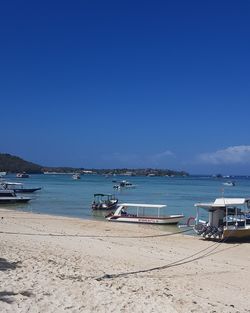 Scenic view of beach against clear blue sky