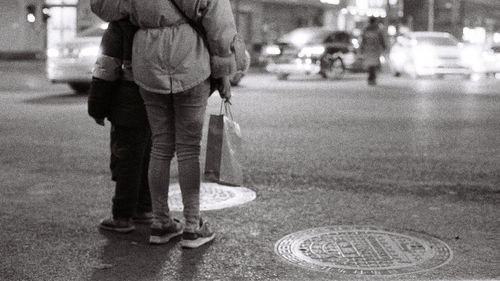 Low section of man walking on road