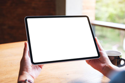 Cropped hand using digital tablet