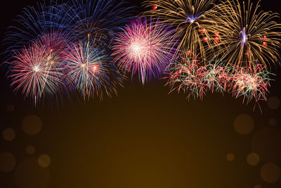 Low angle view of firework display at night