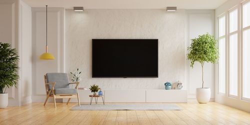 Tv on cabinet have white plaster wall in living room with armchair,minimal design.3d rendering