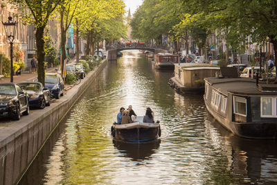 High angle view of people in boat on canal in city