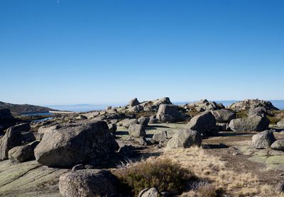 Rock formations against clear blue sky