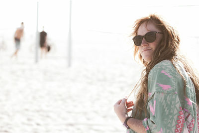 Portrait of woman with sunglasses against sea