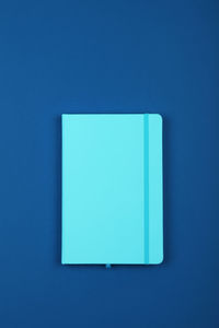 Close-up of blue paper against white background