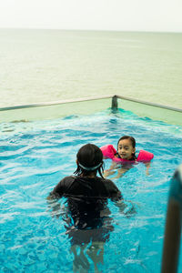 High angle view of girl swimming in pool