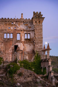 Abandoned building of termas radium spa hotel serra da pena with full moon in sortelha, portugal