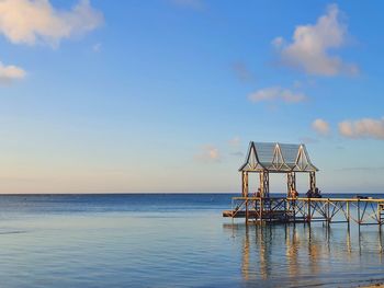 Crane against blue sea against sky