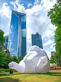 Modern building in park against sky