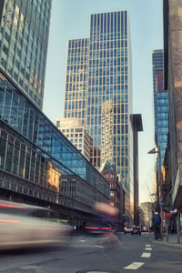 View of city street and buildings against sky