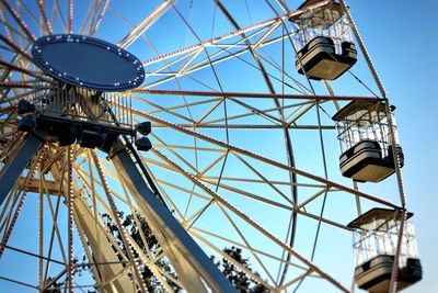 Low angle view of ferris wheel against blue sky