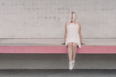 Full length of woman against wall