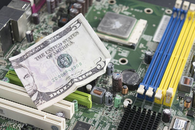 Close-up of computer part with paper currency