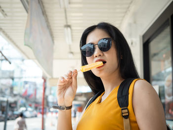 Portrait of young woman eating food