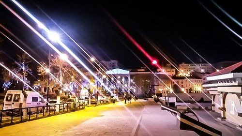 Illuminated street lights in city at night