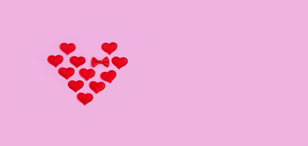 Close-up of heart shapes on pink background