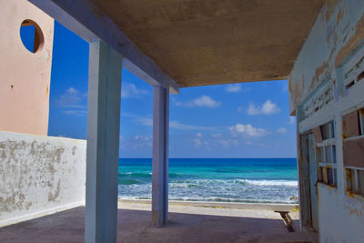 Scenic view of sea against sky seen through window