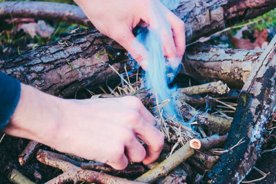 Cropped hands lighting fire