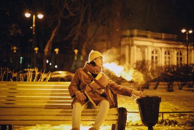 Portrait of man on snow covered street at night