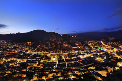 High angle view of illuminated buildings in city at night