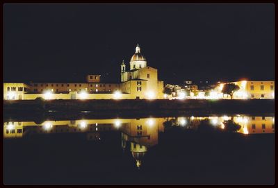 Reflection of illuminated buildings in water at night