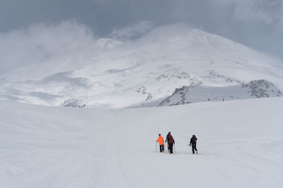 People skiing on snowcapped mountain