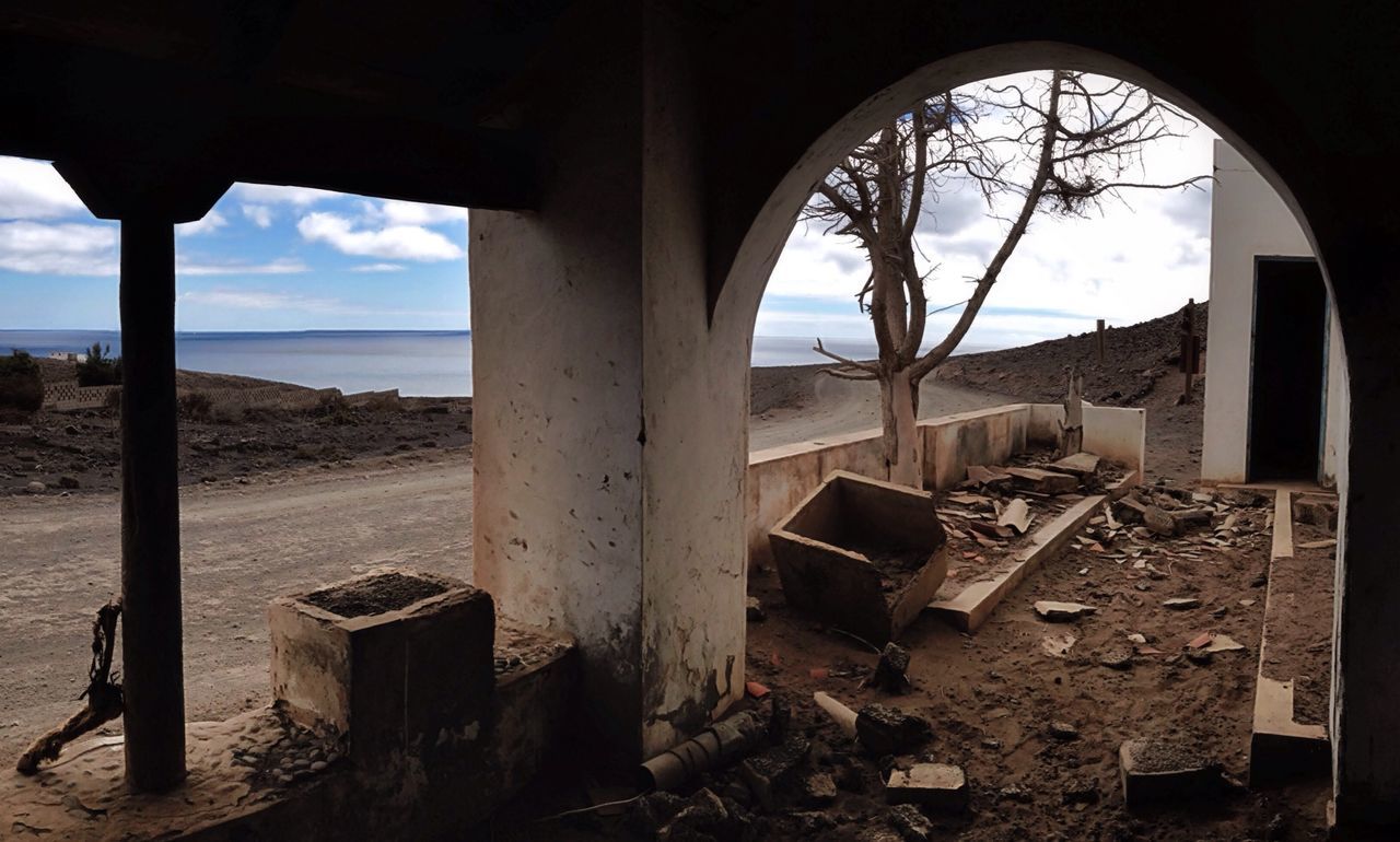 indoors, abandoned, sea, sky, built structure, architecture, beach, horizon over water, obsolete, run-down, old, damaged, window, deterioration, sunlight, ruined, old ruin, day, sand, water