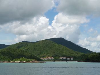 Scenic view of sea and mountains against sky