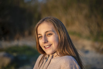 Portrait of smiling young woman outdoors