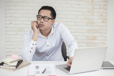 Mid adult man using laptop on table