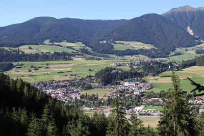 Scenic view of landscape and houses against sky