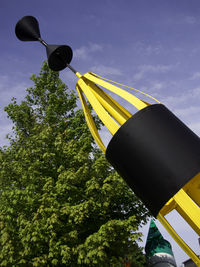 Low angle view of yellow street light against sky